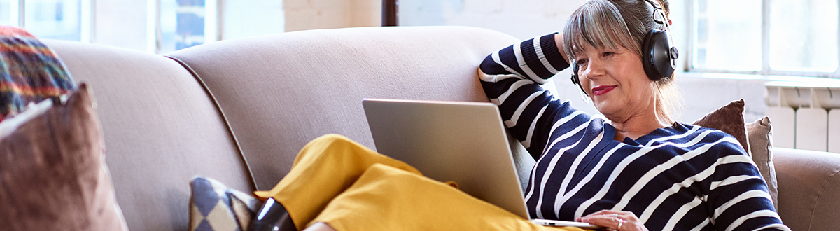 Woman on her laptop researching audience measurement solutions relevant to TV and streaming measurement.
